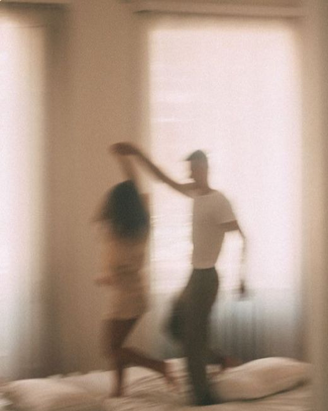 Couple dancing in light room